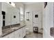 Bathroom with granite countertop, white cabinets, and gray floor tile at 13012 Rain Lily Dr, Riverview, FL 33579