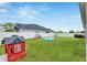 Spacious backyard with grassy lawn, playset, and small pool at 13012 Rain Lily Dr, Riverview, FL 33579