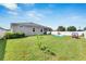 Large backyard with grassy area, small tree, and playset at 13012 Rain Lily Dr, Riverview, FL 33579