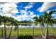 Beautiful view of a lake with lush landscaping and homes at 28758 Lucero Ln, Wesley Chapel, FL 33543