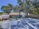 Backyard showcases a spacious wooden deck, shed, and mature trees at 4477 67Th N St, St Petersburg, FL 33709