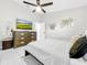 Bright bedroom with a ceiling fan, TV, dresser, and a big window, all contributing to a comfortable aesthetic at 4477 67Th N St, St Petersburg, FL 33709