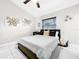 Bright bedroom with a ceiling fan, a nightstand, and a big window, all contributing to a comfortable aesthetic at 4477 67Th N St, St Petersburg, FL 33709