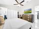 Bright bedroom with a ceiling fan, closet, dresser, and a big TV, all contributing to a comfortable aesthetic at 4477 67Th N St, St Petersburg, FL 33709