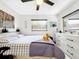 Bright bedroom featuring a ceiling fan, window, and a modern dresser, all contributing to a comfortable aesthetic at 4477 67Th N St, St Petersburg, FL 33709