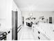 Bright dining space features a modern light fixture and flows to the kitchen and bar at 4477 67Th N St, St Petersburg, FL 33709
