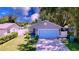 Charming single-story home features a blue garage door, manicured lawn, and cozy porch at 4477 67Th N St, St Petersburg, FL 33709