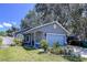 Charming single-story home features a blue garage door, manicured lawn, and cozy porch at 4477 67Th N St, St Petersburg, FL 33709