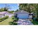 Charming home featuring a well-kept lawn, attached garage, and beautifully landscaped front yard at 4477 67Th N St, St Petersburg, FL 33709