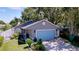 Inviting home with a well-manicured lawn, a two-car garage and lovely front yard landscaping at 4477 67Th N St, St Petersburg, FL 33709