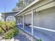 Charming covered front porch features elegant seating and well-maintained landscaping at 4477 67Th N St, St Petersburg, FL 33709