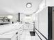 Spacious kitchen featuring white cabinetry, quartz countertops, a breakfast bar, and modern appliances at 4477 67Th N St, St Petersburg, FL 33709
