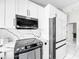 Updated kitchen features sleek, stainless steel appliances, including a modern range and microwave at 4477 67Th N St, St Petersburg, FL 33709