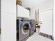 Well-equipped laundry room featuring modern washer and dryer units, storage cabinets, and convenient access to the exterior at 4477 67Th N St, St Petersburg, FL 33709