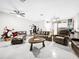Open living area with comfortable leather seating, ceiling fans, and a gray epoxy floor creating a relaxed atmosphere at 4477 67Th N St, St Petersburg, FL 33709
