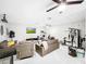 Comfortable living area showcasing leather seating, ceiling fans, and exercise equipment, perfect for active relaxation at 4477 67Th N St, St Petersburg, FL 33709