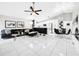 Spacious living room featuring tile floors, modern decor, and an open layout flowing into the dining and kitchen areas at 4477 67Th N St, St Petersburg, FL 33709