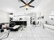 Bright living room features modern decor, sleek tile floors, and an open layout to kitchen and dining at 4477 67Th N St, St Petersburg, FL 33709