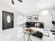 Stylish living area with tile floors, modern furnishings, and an open layout connecting to the adjacent kitchen at 4477 67Th N St, St Petersburg, FL 33709