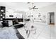 Spacious living room featuring tile floors, modern decor, and an open layout flowing into the dining and kitchen areas at 4477 67Th N St, St Petersburg, FL 33709