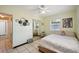 Bedroom with mirrored closet doors, ceiling fan, and access to the bathroom at 627 61St S Ave, St Petersburg, FL 33705