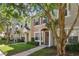 Two story townhome with light colored siding and brown door at 4538 Kennewick Pl, Riverview, FL 33578