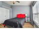 Bright bedroom with a red accent wall and ample closet space at 4538 Kennewick Pl, Riverview, FL 33578