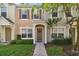 Two story townhome with a brown door and neutral colors at 4538 Kennewick Pl, Riverview, FL 33578