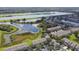 Aerial view of community with lake, lush landscaping, and townhouses at 4538 Kennewick Pl, Riverview, FL 33578