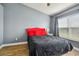 Cozy bedroom with a red headboard and black bedding at 4538 Kennewick Pl, Riverview, FL 33578