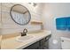 Modern bathroom with a white sink, dark vanity, and patterned tile floor at 4538 Kennewick Pl, Riverview, FL 33578