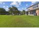 Large grassy backyard with a view of neighboring homes at 4538 Kennewick Pl, Riverview, FL 33578