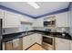 Updated kitchen with stainless steel appliances and corner sink at 19029 Us Highway 19 N # 6-19, Clearwater, FL 33764