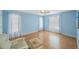 Light and airy bedroom with light blue walls and hardwood floors at 19029 Us Highway 19 N # 6-19, Clearwater, FL 33764