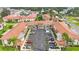 Aerial view of condo building with parking lot and landscaping at 19029 Us Highway 19 N # 6-19, Clearwater, FL 33764