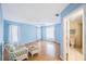 Bright bedroom with light blue walls, hardwood floors and bathroom access at 19029 Us Highway 19 N # 6-19, Clearwater, FL 33764