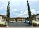 Condo building exterior with parking and landscaping at 19029 Us Highway 19 N # 6-19, Clearwater, FL 33764