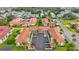 Aerial view of condo building with parking and surrounding landscape at 19029 Us Highway 19 N # 6-19, Clearwater, FL 33764