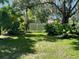 Landscaped backyard with tropical plants and a privacy fence at 200 Race Track S Rd, Oldsmar, FL 34677