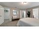 Bright bedroom with a queen bed, built-in closet, and bench at 10448 Laguna Plains Dr, Riverview, FL 33578