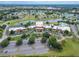 Beautiful aerial view of the community clubhouse, parking, and the pond at 120 Knollpoint Dr, Sun City Center, FL 33573