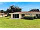 Lovely backyard featuring a well-manicured lawn and a charming patio area perfect for outdoor enjoyment at 120 Knollpoint Dr, Sun City Center, FL 33573
