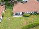 Bird's eye view of a backyard with a patio, green lawn and trimmed shrubs offers a private outdoor retreat at 120 Knollpoint Dr, Sun City Center, FL 33573