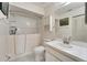Bathroom featuring walk-in tub, tiled floor and shower with an updated white vanity at 120 Knollpoint Dr, Sun City Center, FL 33573