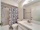 Bathroom featuring vanity and white tiled shower/tub with decorative shower curtain at 120 Knollpoint Dr, Sun City Center, FL 33573