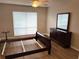 Empty bedroom with wood floors featuring a dresser, mirror, and natural light from the window at 120 Knollpoint Dr, Sun City Center, FL 33573