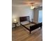 Bedroom featuring a ceiling fan, natural light, and hardwood floors at 120 Knollpoint Dr, Sun City Center, FL 33573