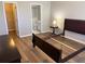 Bedroom with ensuite bathroom and walk-in closet, featuring hardwood flooring and neutral paint at 120 Knollpoint Dr, Sun City Center, FL 33573