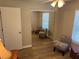 Bedroom featuring mirror closet doors, hardwood flooring, and natural light from the window at 120 Knollpoint Dr, Sun City Center, FL 33573