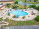 Aerial shot of a resort style community pool featuring a large pool deck and lounge seating at 120 Knollpoint Dr, Sun City Center, FL 33573
